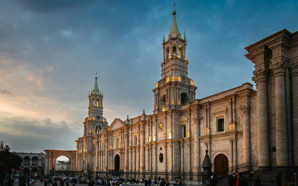 The Basilica Cathedral of Arequipa illuminated at sunset, showcasing its stunning architecture.