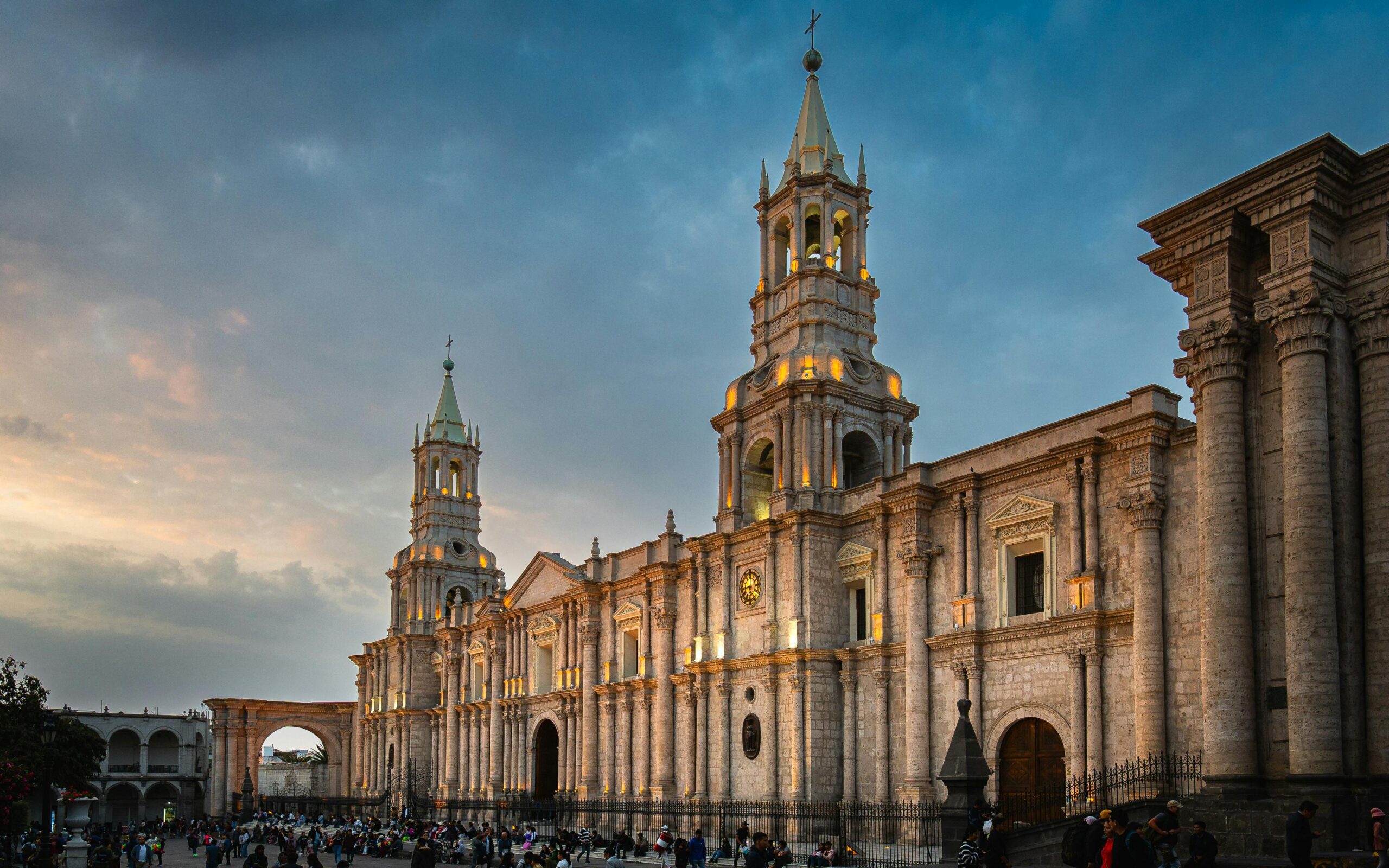 The Basilica Cathedral of Arequipa illuminated at sunset, showcasing its stunning architecture.