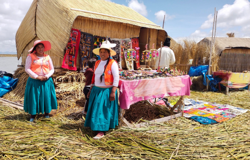 Women in traditional clothing at a market in Uros floating islands, Lake Titicaca.