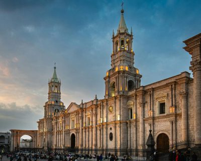 The Basilica Cathedral of Arequipa illuminated at sunset, showcasing its stunning architecture.