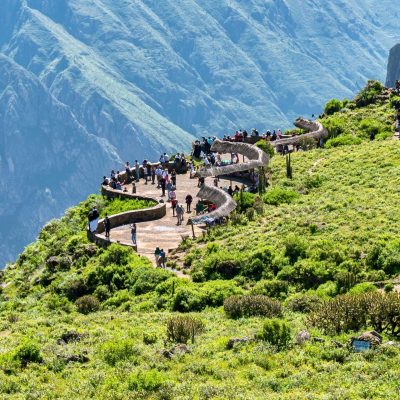 Tourists enjoy a breathtaking view from a scenic overlook at Colca Canyon in Arequipa, Peru.