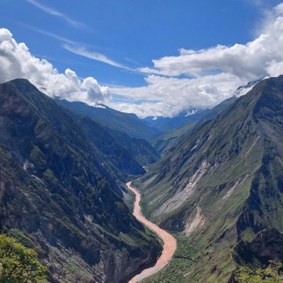 Breathtaking aerial view of a majestic mountain canyon with a winding river.